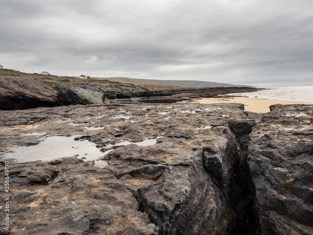 West coast of Ireland, stone formation, cloudy day, low tide. County Clare, Ireland.