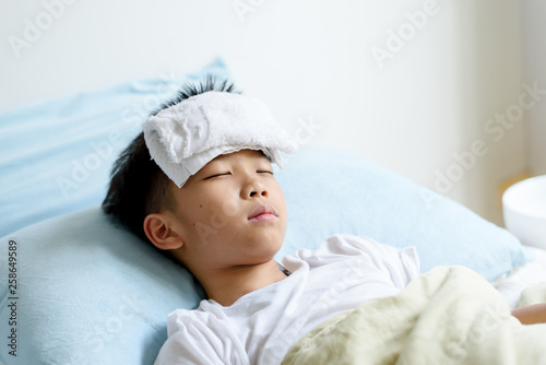 Young boy sick and sleep on the bed