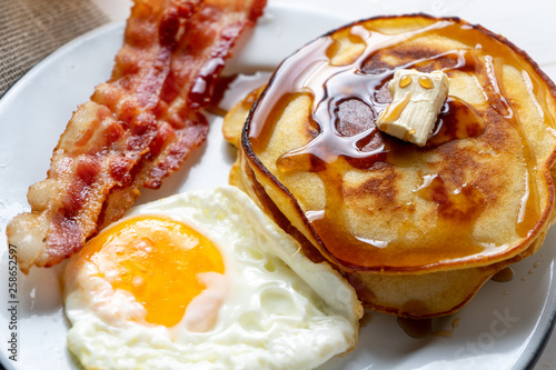 American breakfast with egg, pancake and bacon photo