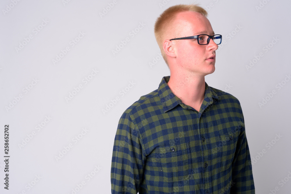 Portrait of young blonde hipster man with eyeglasses thinking Portrait of young blonde hipster man with eyeglasses thinking