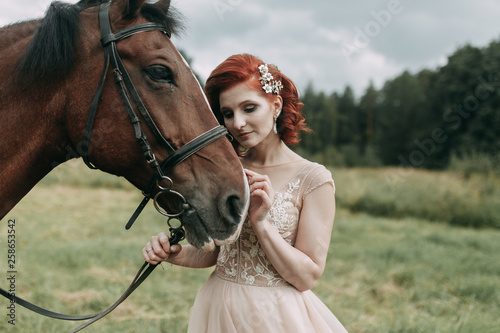 The bride on a horse in the field. Beautiful wedding and photo shoot with a horse.