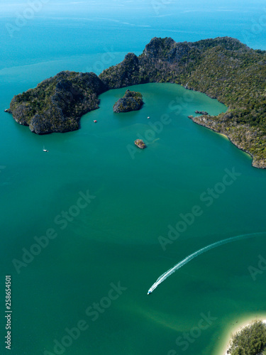 Aerial view of island in sea. Boat float near the island. Park Kilim Geforest, Langkawi, Malaysia.