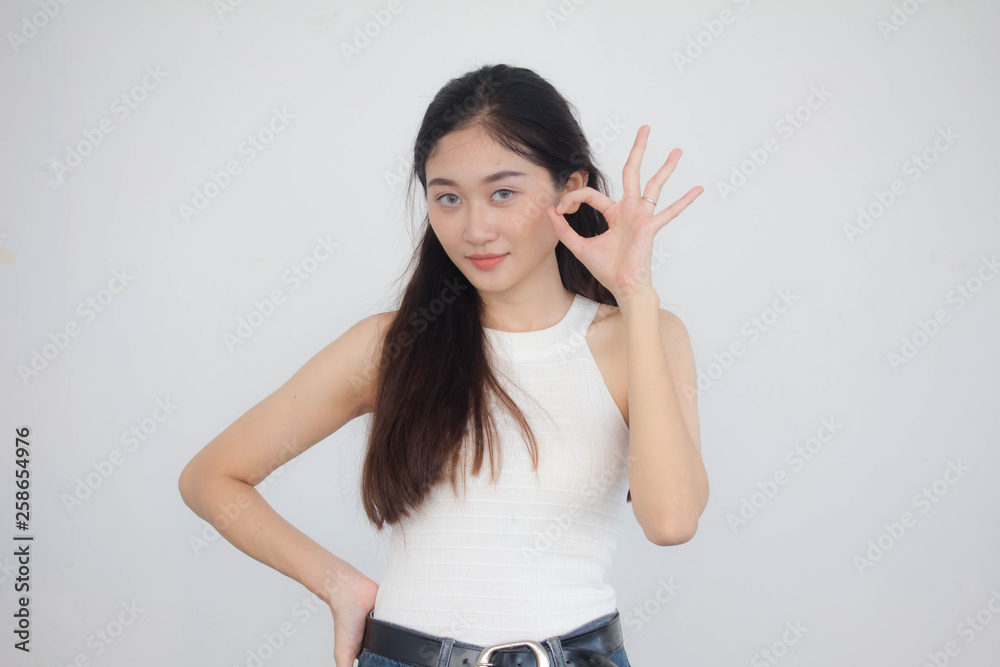 Portrait of thai china adult beautiful girl White shirt blue jeans OK Portrait of thai china adult beautiful girl White shirt blue jeans OK
