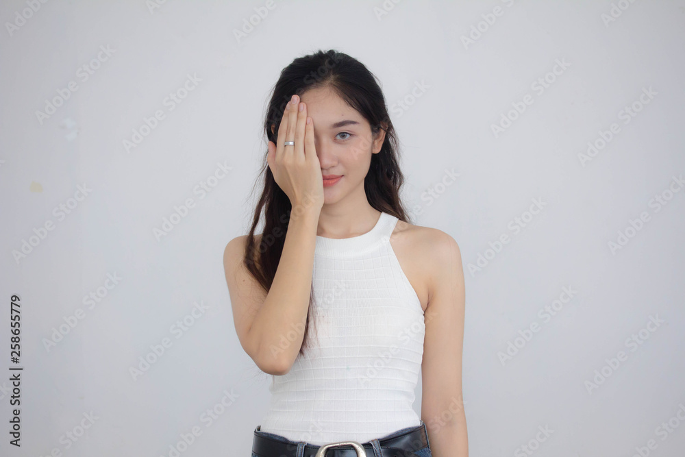 Portrait of thai china adult beautiful girl White shirt blue jeans Eyes closed Portrait of thai china adult beautiful girl White shirt blue jeans Eyes closed