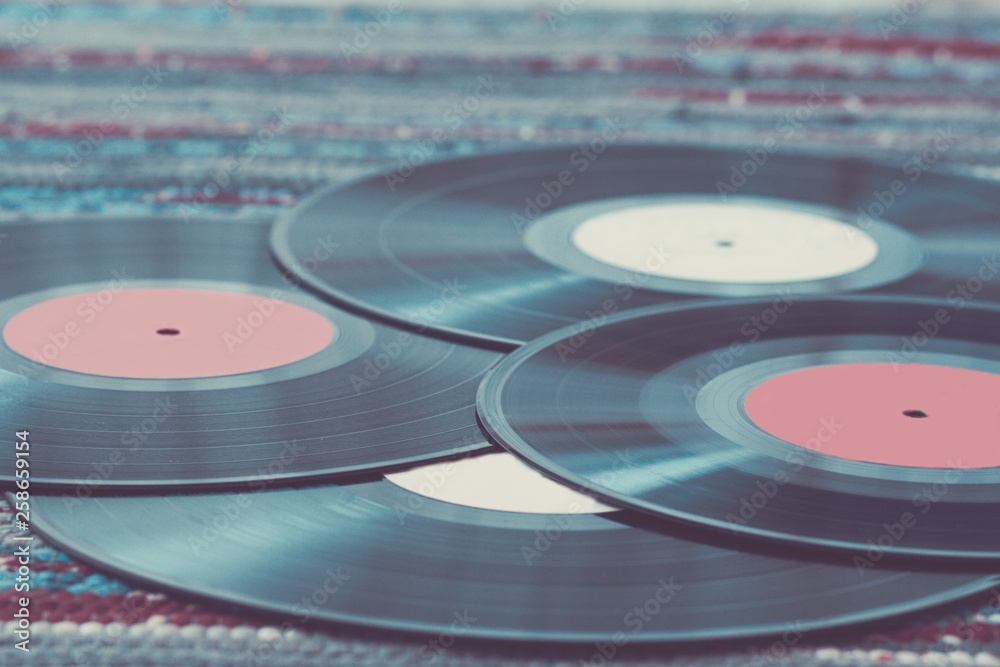 Old vinyl records, selective focus and toned image. Retro styled image of a collection of old vinyl records. Old vinyl records, selective focus and toned image. Retro styled image of a collection of old vinyl records.