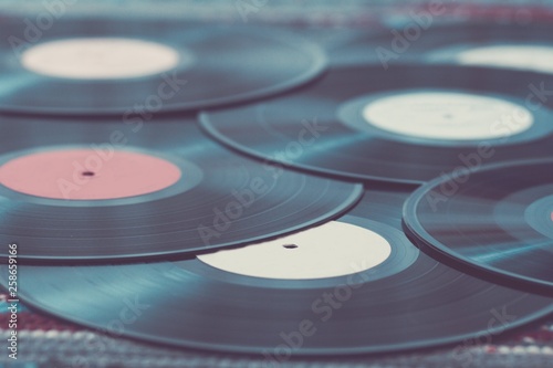 Old vinyl records, selective focus and toned image. Retro styled image of a collection of old vinyl records.
