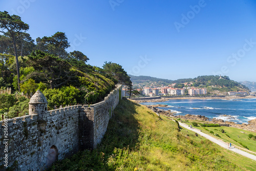 Baiona, Spain. View of the walls of the fortress of Monterreal on the sea and city photo