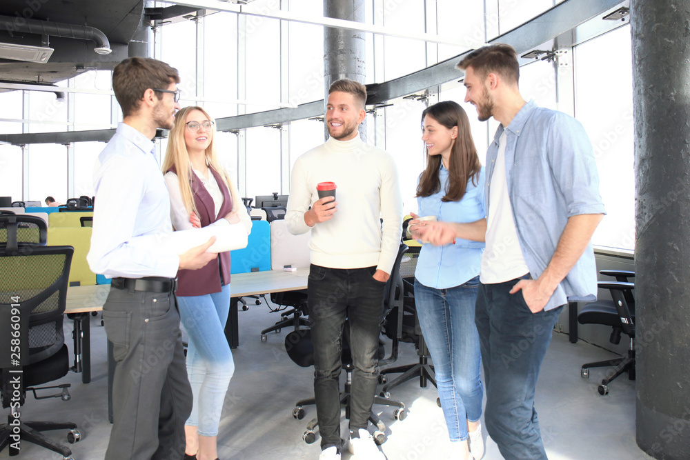 Group of young business people and designers in smart casual wear. They working on new project. Group of young business people and designers in smart casual wear. They working on new project.