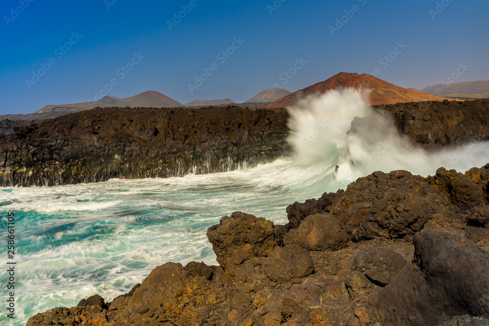 Spain, Lanzarote, Atlantic ocean waves breaking at los hervideros lava bay showing force of nature