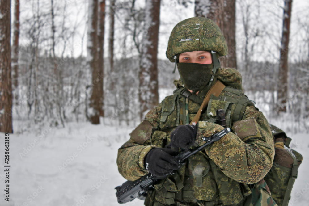 A girl stands with a gun. Winter. Army. A man stands with a gun. Russian soldier with AK-74.