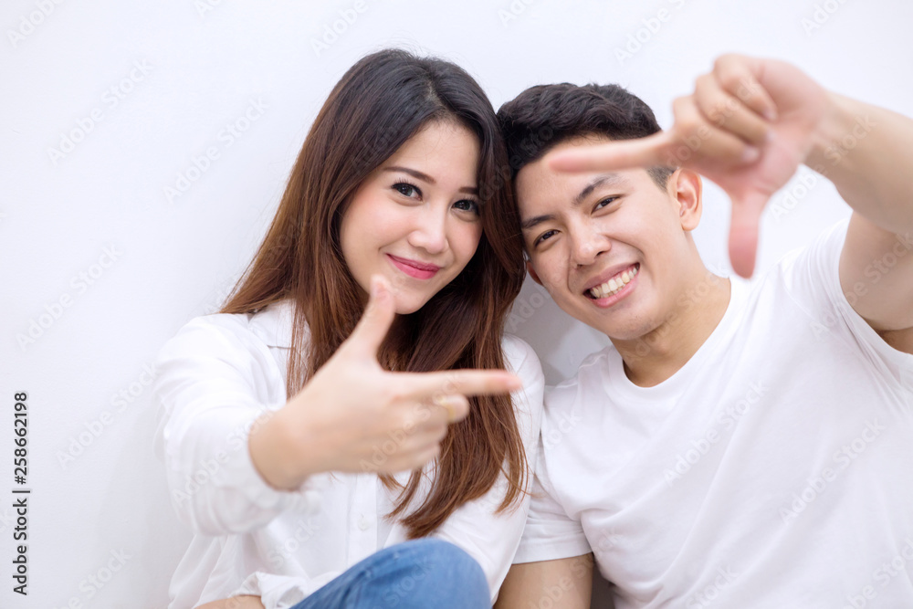 Young happy couple making frame with their fingers Young happy couple making frame with their fingers