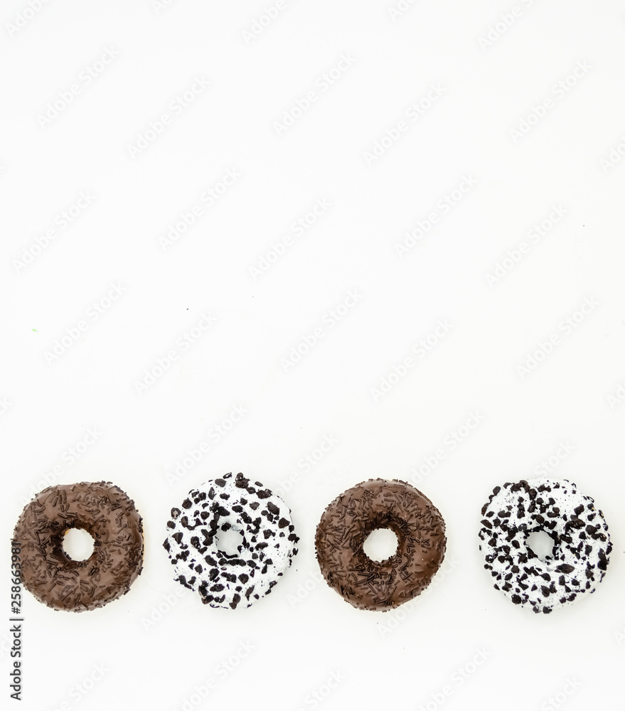 Donuts  with chocolate glazed with sprinkles donuts isolated on white black abstract background