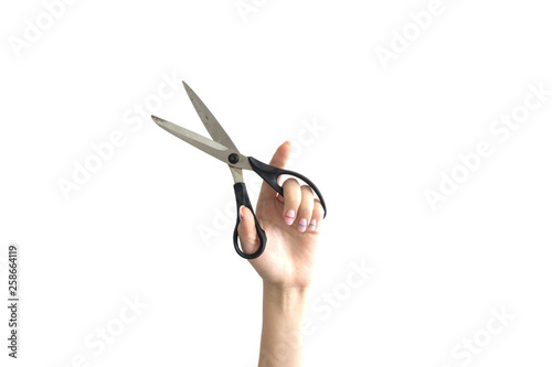 girl holds scissors on white background