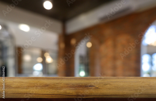Empty wooden table in front of abstract blurred background of restaurant, cafe and coffee shop interior. can be used for display or montage your products - Image. © Supitnan