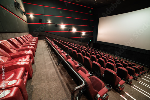 Empty cinema auditorium with screen and seats. Mock Up.