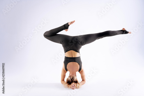 Skinny blonde woman moving her legs in the air