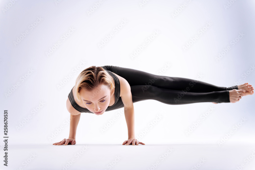 Beautiful strong woman standing on her hands Beautiful strong woman standing on her hands
