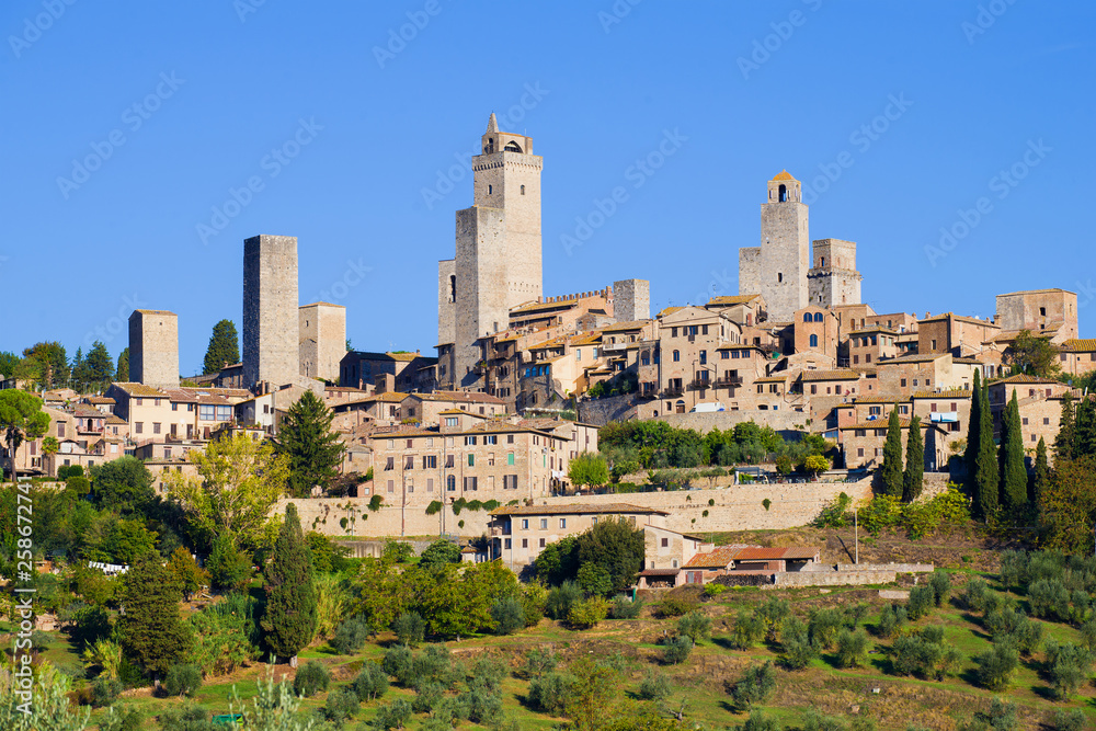 City landscape of the medieval town in the sunny September afternoon. San Gimignano, Italy