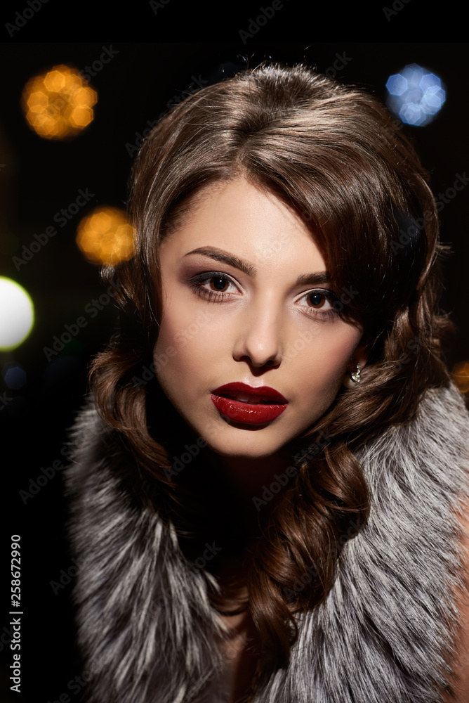 Retro portrait of young beautiful woman with fur collar, background with different highlights Retro portrait of young beautiful woman with fur collar, background with different highlights