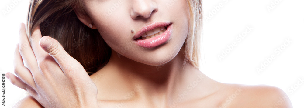 Part of beauty girl face. Model woman hold hand near hair. Elegant lady perfect lips, skin, make-up. Skincare facial treatment female health concept Part of beauty girl face. Model woman hold hand near hair. Elegant lady perfect lips, skin, make-up. Skincare facial treatment female health concept