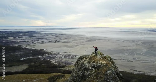Man pointing in the distance an a mountain peak aerial 4k