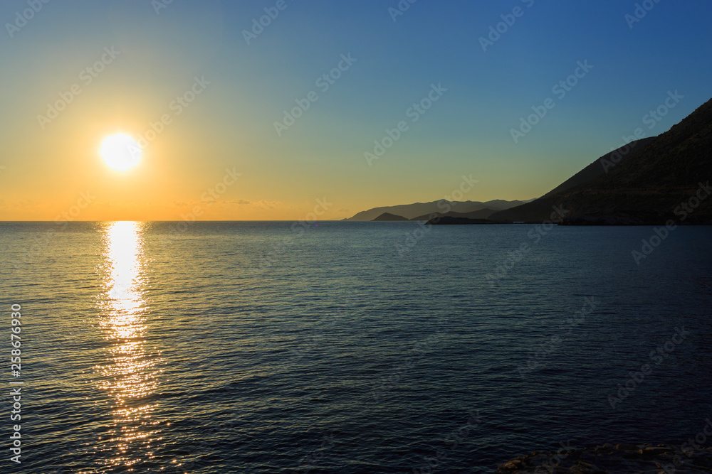 Sunrise over the mountains and the sea.