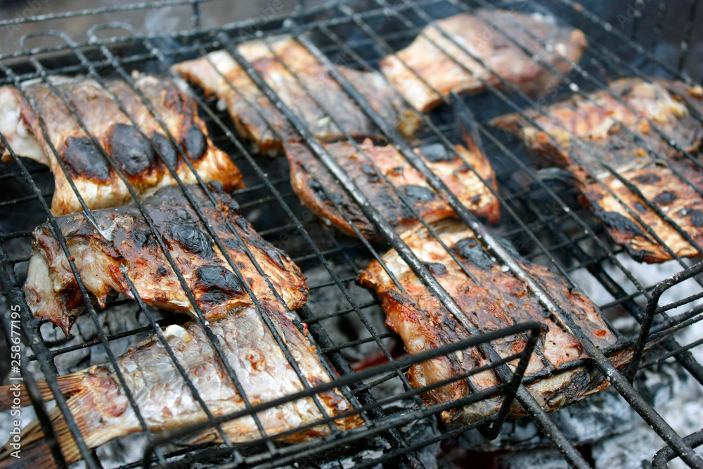 grilled fish in the grill closeup. BBQ