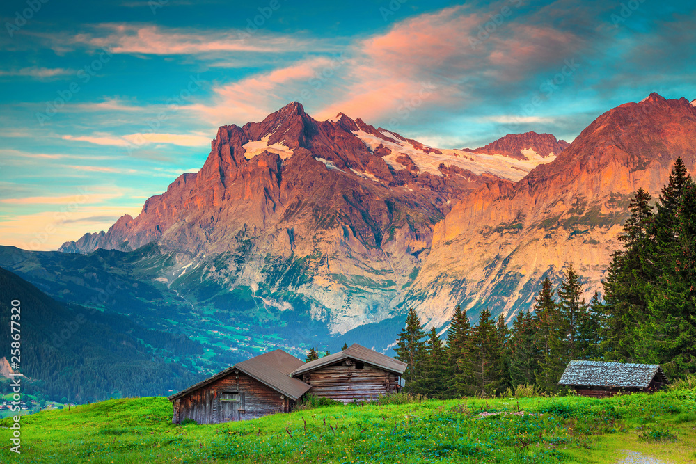 Amazing summer alpine landscape with old wooden lodges, Grindelwald, Switzerland Amazing summer alpine landscape with old wooden lodges, Grindelwald, Switzerland