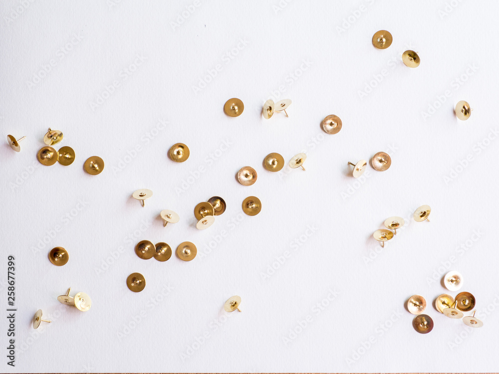 Fototapeta premium metallic pushpins on white paper