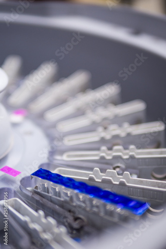 Part of centrifuged machine in hospital’s laboratory room .The blue line is gel card cover slip.(selective focus)