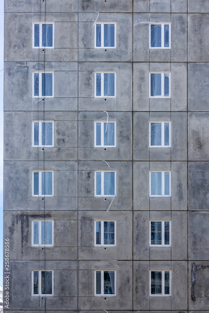 Background of windows wall of panel box building of cheap housing
