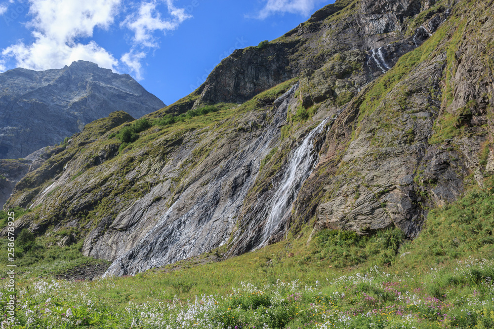 Panorama view of waterfall scene in mountains, national park of Dombay, Caucasus