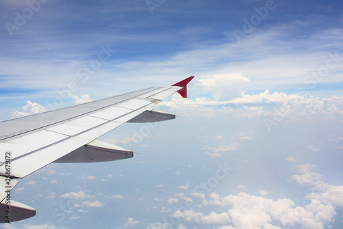 airplane wing look from airplane window above the sky