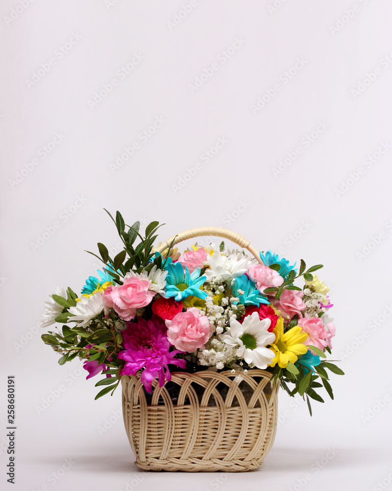 basket of flowers on a light background. congratulations, empty space for Your text.