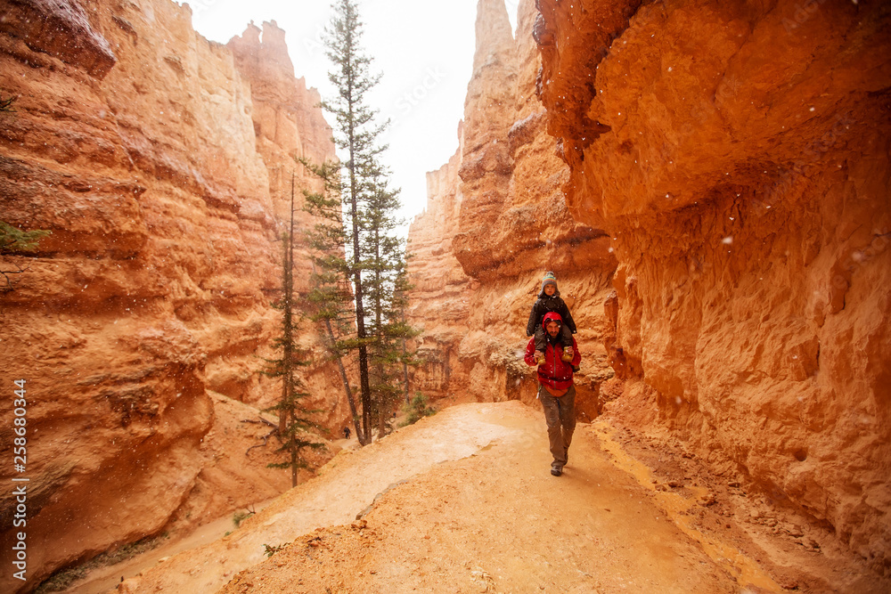 Father with son are hiking in Bryce canyon National Park, Utah, USA