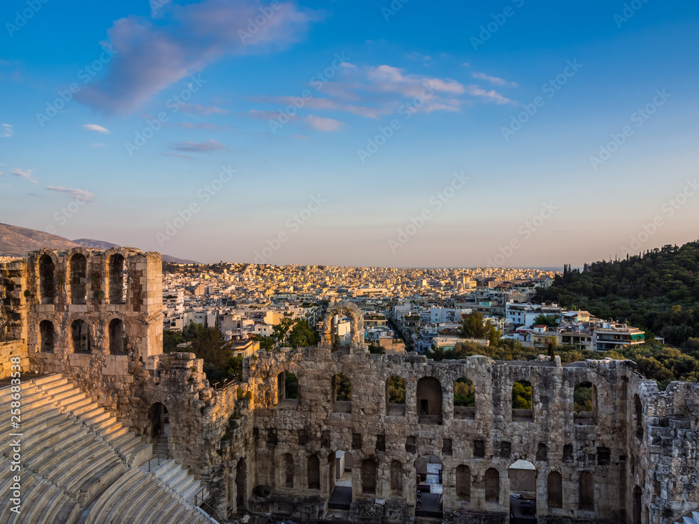 View of Odeon of Herodes Atticus theater on Acropolis hill, Athens, Greece, overlooking the city at sunset