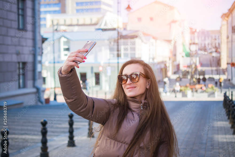 Fototapeta premium Attractive young woman making selfie