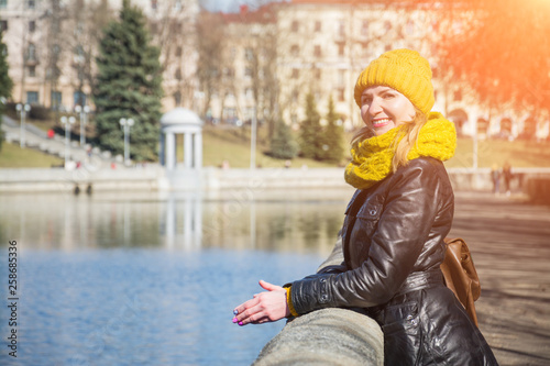 beautiful girl stands near the city river