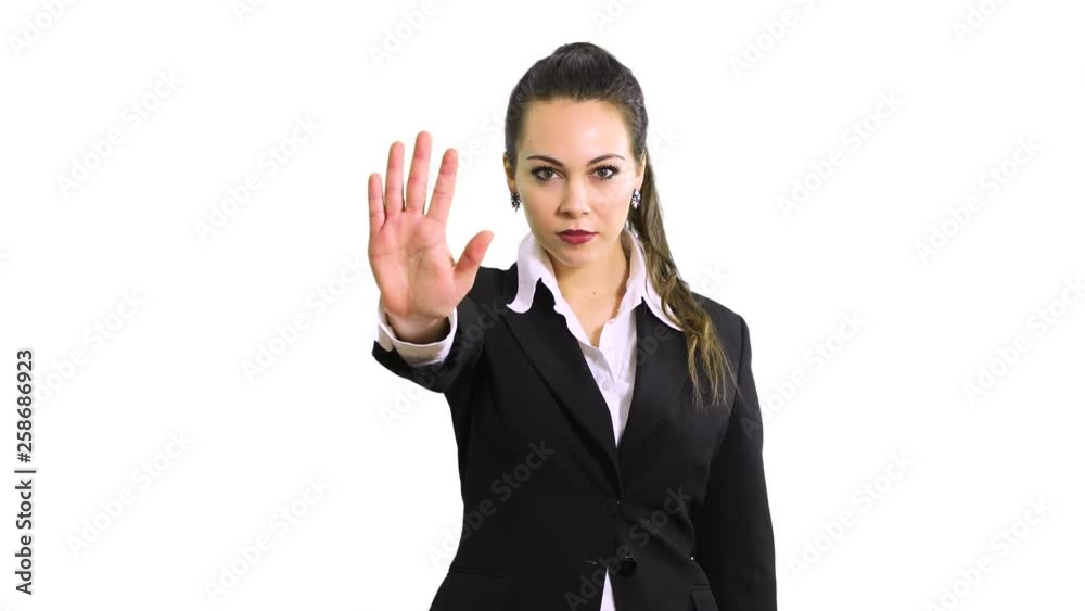 Young serious beautiful woman showing stop sign. Prohibition symbol Young serious beautiful woman showing stop sign. Prohibition symbol
