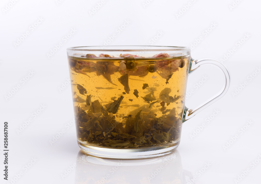 Glass cup of hot aromatic roses tea on white background Glass cup of hot aromatic roses tea on white background