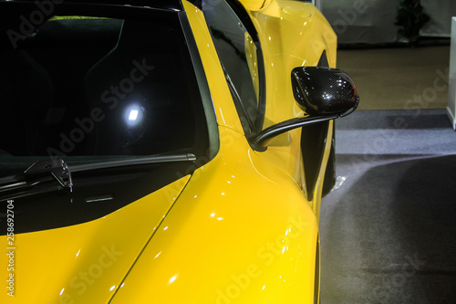 Shiny Yellow super car, close-up of front parts in detail, headlights, hoods and bumpers, sports car concept image.