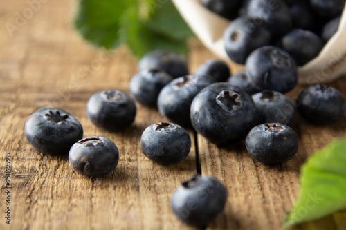 Fresh blueberries, close up on rustic wooden surface. Concept for healthy eating and nutrition.