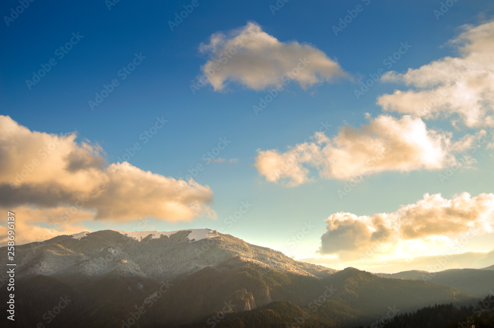 Bright sunrise light over the mountains, seen from Predeal city