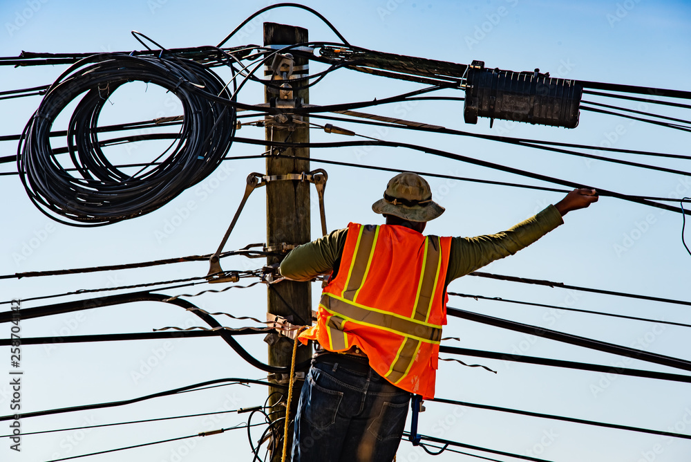 custom made wallpaper toronto digitalElectrical Lineman on ladder working at utility pole