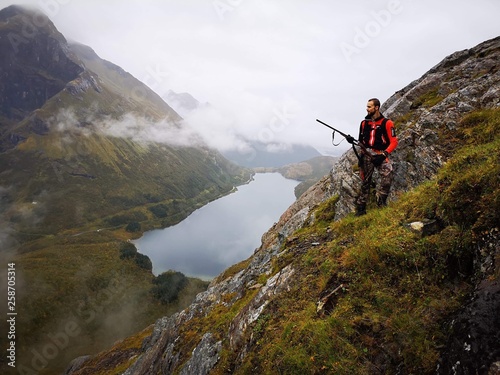 Hunting trip on a mountain with beautiful lake in background