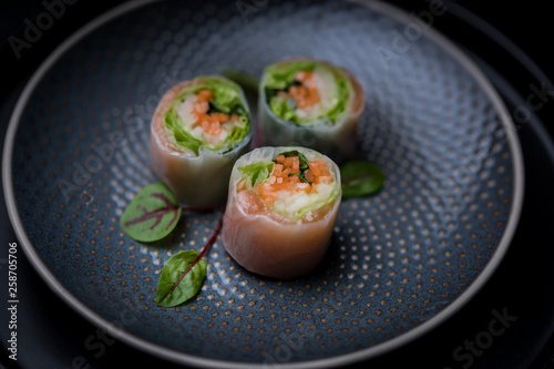 nori free maki sushi with carrots salad and salmon no seaweed on dark plate