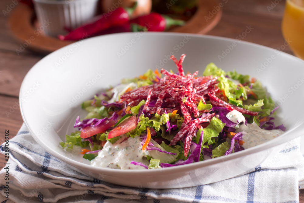 Mediterranean cuisine. Fresh salad with arugula, tomatoes, red cabbage, cucumber and yogurt sauce Mediterranean cuisine. Fresh salad with arugula, tomatoes, red cabbage, cucumber and yogurt sauce