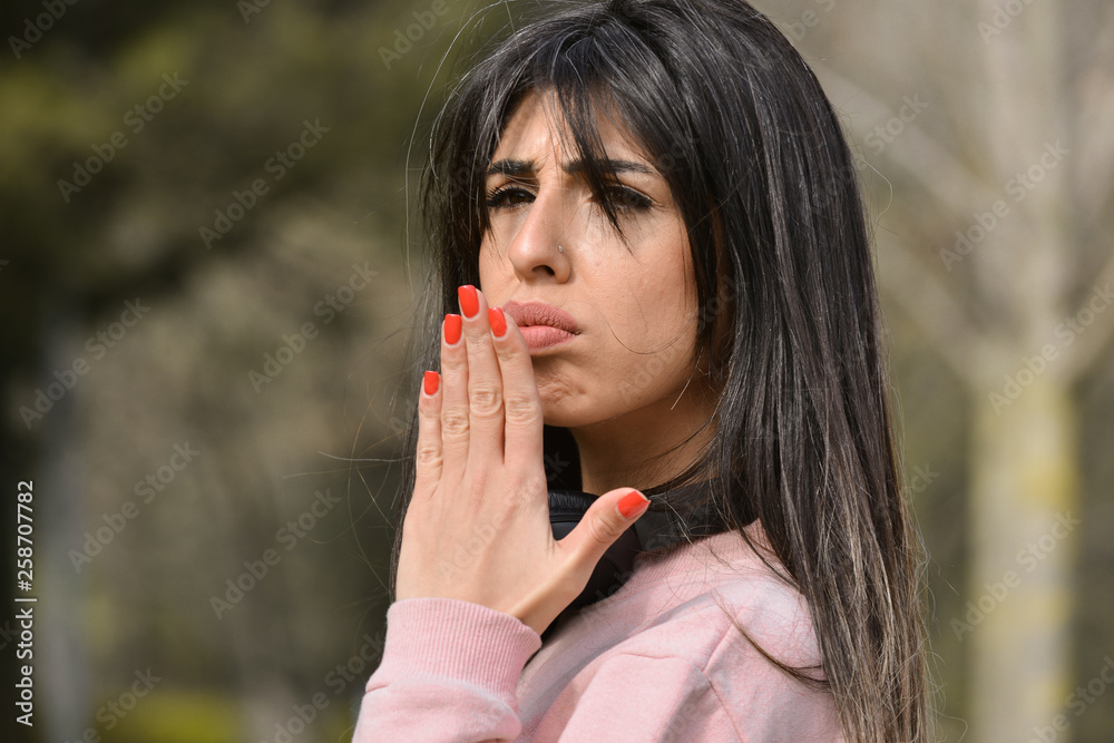 Attractive young woman enjoying her time outside in park with confused expression on face Attractive young woman enjoying her time outside in park with confused expression on face