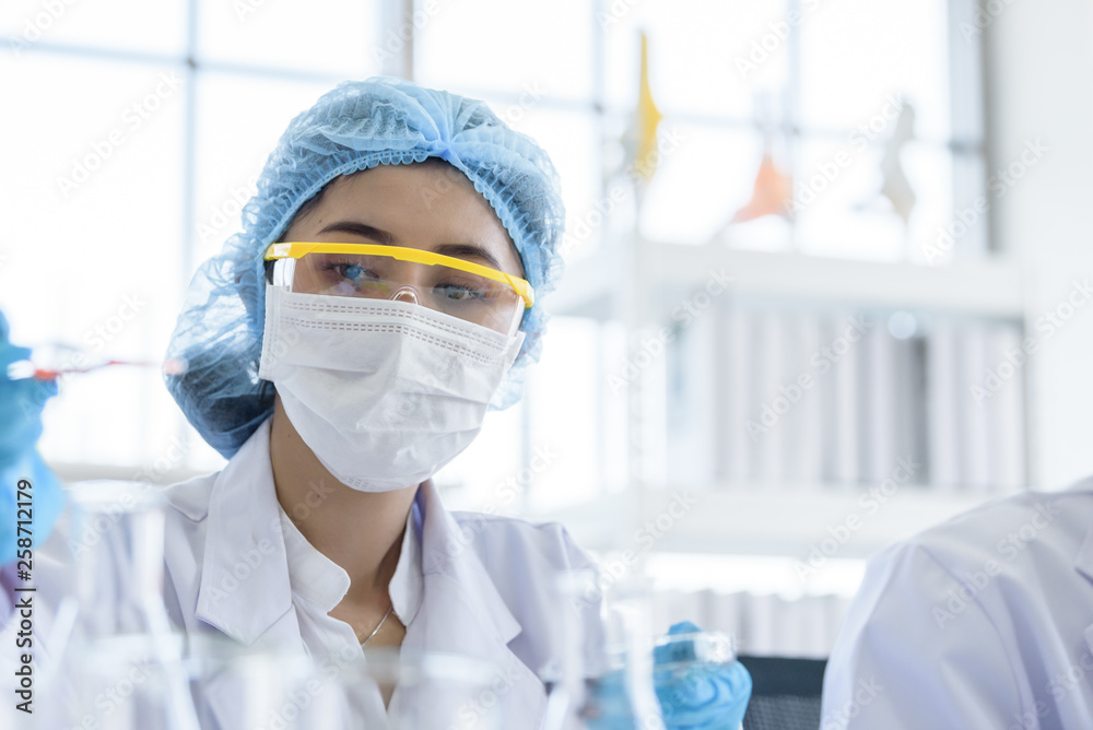 Asian young girl student scientist researching and learning in a laboratory. Asian young girl student scientist researching and learning in a laboratory.