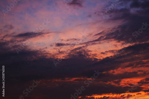 Evening sky. Bright pink sky with clouds.